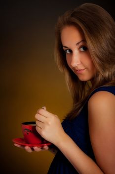 beautiful girl with cup of coffee, yellow background