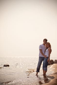 beautiful couple on a seashore, toned