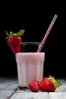 strawberry milkshake with whole strawberry on side