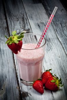 strawberry milkshake with whole strawberry on side