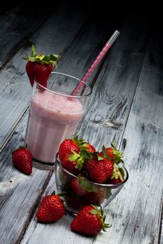 strawberry milkshake with whole strawberry on side