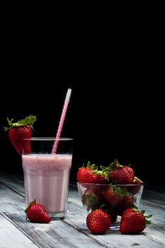 strawberry milkshake with whole strawberry on side