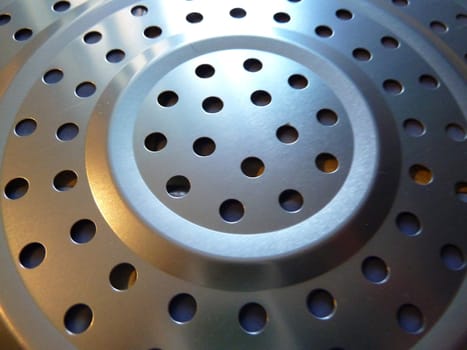 closeup of a piece of round punched metal