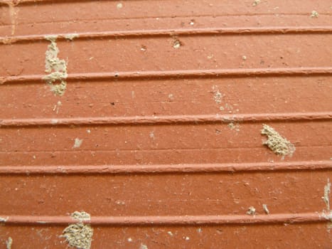 closeup of splattered cement on brick