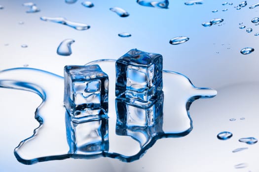 ice cube with pure water on reflective surface