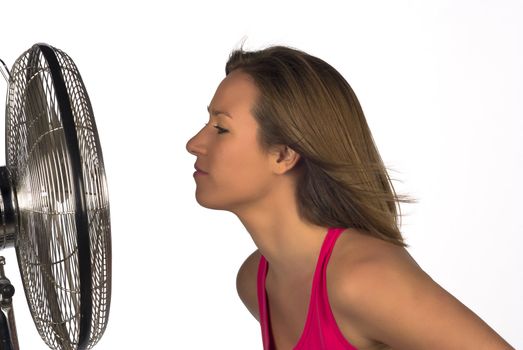 Face next to a fan, a summer concept