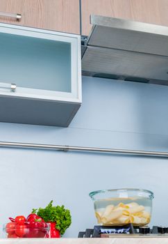 Clouseup range hood - detail of a modern kitchen. Vertical view