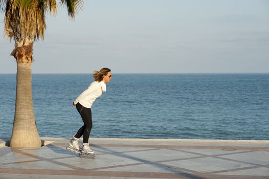 Woman enjoying her hobby on a sunny beach promenade