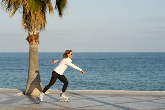 Skating along a beach promenade, shot by camera panning