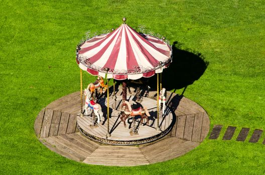 the small carousel in green grass
