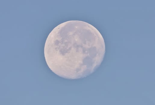 the moon in a blue sky