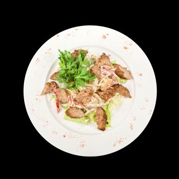 Tasty salad of meat and vegetable dish close up on a white background