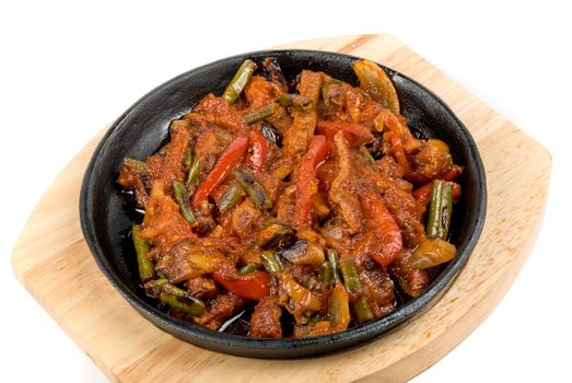 Roasted meat and vegetables at pan on a white background