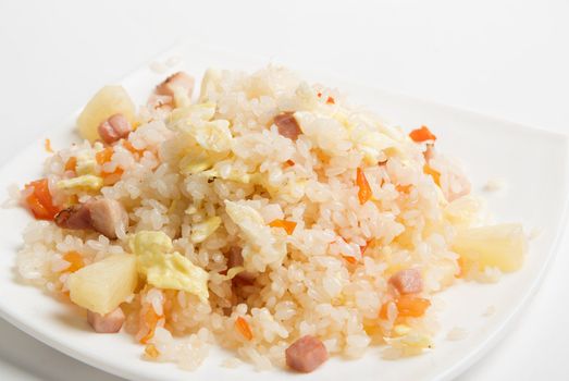 Rice with vegetable on a plate isolated over white
