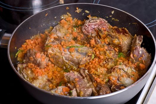 Beef sliced meat cooking in frying pan
