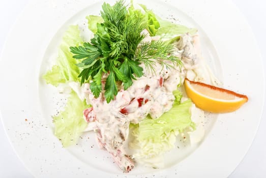 Tasty salad of seafood and vegetable close up on a white background