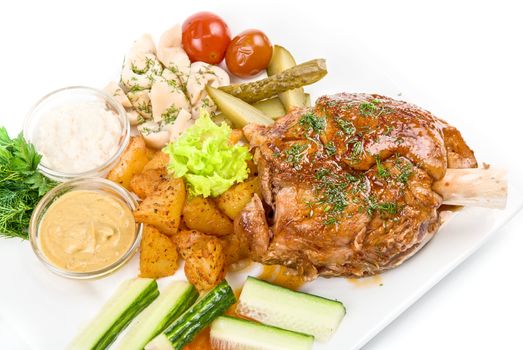 Tasty pork dish with vegetables on a white background