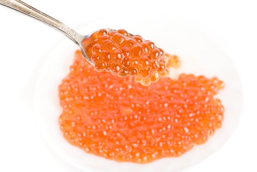 red caviar with spoon on a white background
