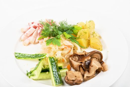Tasty snacks: potato, fat and vegetables  at plate isolated on a white