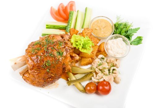 Tasty pork dish with vegetables on a white background