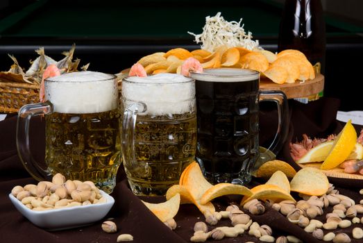 Beer and snacks set: chips, pistachio, shrimp and fish