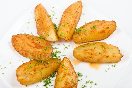 Baked potatoes closeup with greens on a white background