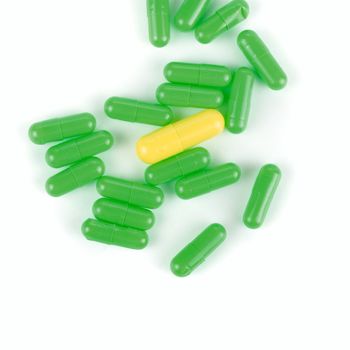 Green and yellow pills isolated on a white background