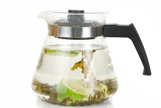 Kettle with green tea isolated on a white background