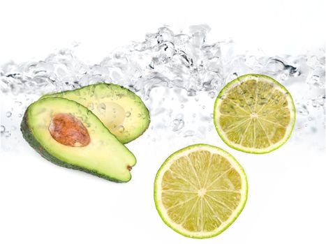 Green limes and avocado in water dropped isolated on a white