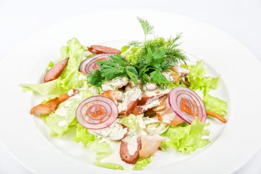 Tasty salad dish close up with sausage and vegetables on a white background