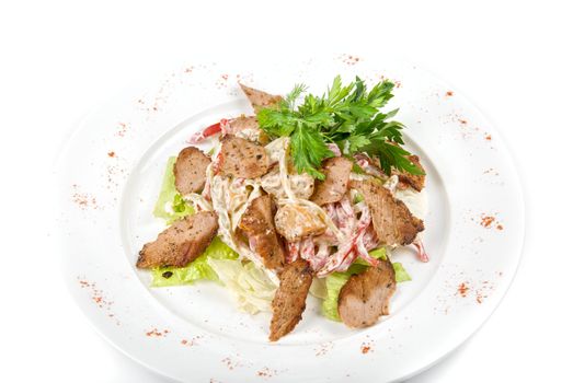 Tasty salad of meat and vegetable dish close up on a white background