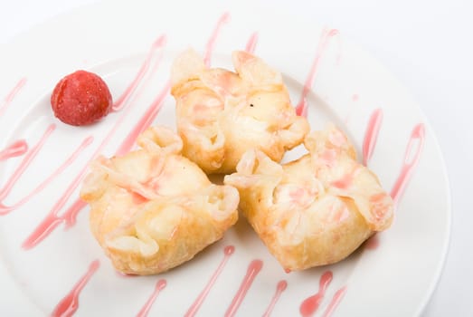 cakes closeup on a white plate drizzled with strawberry sauce