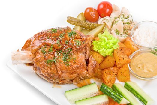 Tasty pork meat dish with vegetables on a white background