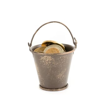 bucket full of coins isolated on a white