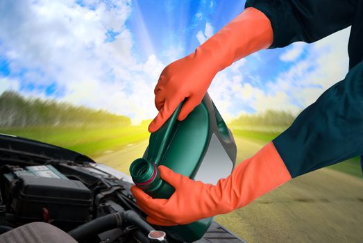 man pours motor oil into the engine