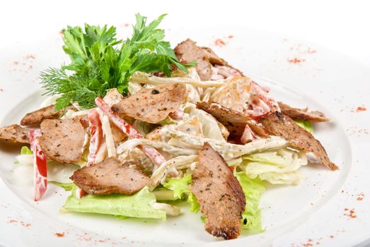 Tasty salad of meat and vegetable dish close up on a white background