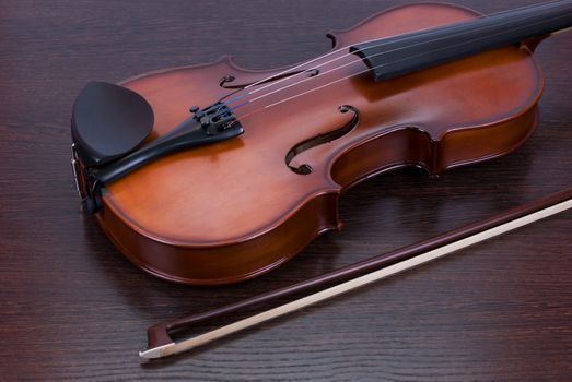 classic violin closeup on a brown wooden background