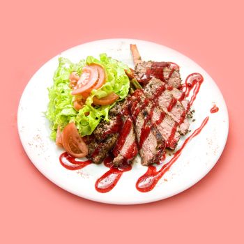 Roasted Beef meat at cranberries sauce with vegetables