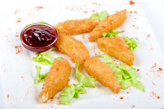 Tasty Baked cheese with cranberries sauce isolated on white