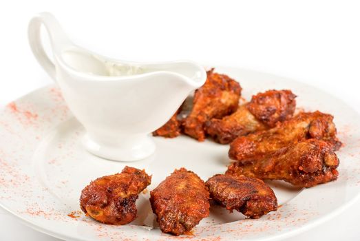 chicken wings with sauce closeup at white plate