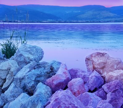 blue and purple stones on riverbank over cyan Danube river landscape