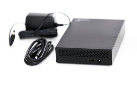Photo of an external hard disk drive with USB 3.0 with its USB cable and connector.