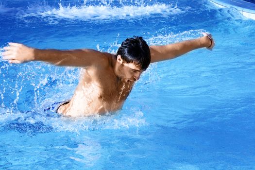 man swims in swimming pool