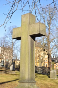 old stone cross in a cemetery.
