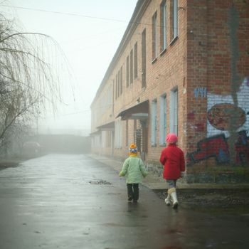 An image of two little children walking