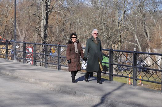 Older couple on a walk holding hands.