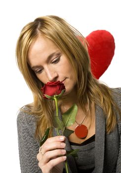 Young woman with a red rose on white background