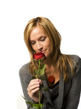 Young woman with a red rose on white background