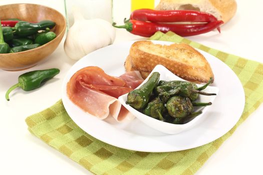 Pimientos with Salt, nuts ham and sauteed baguette