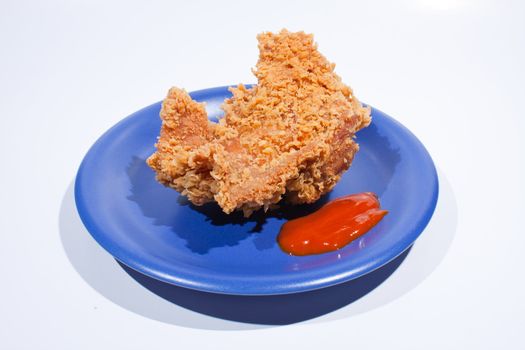 Fried chicken dish dark blue. Placed on a white background, then shoot.
